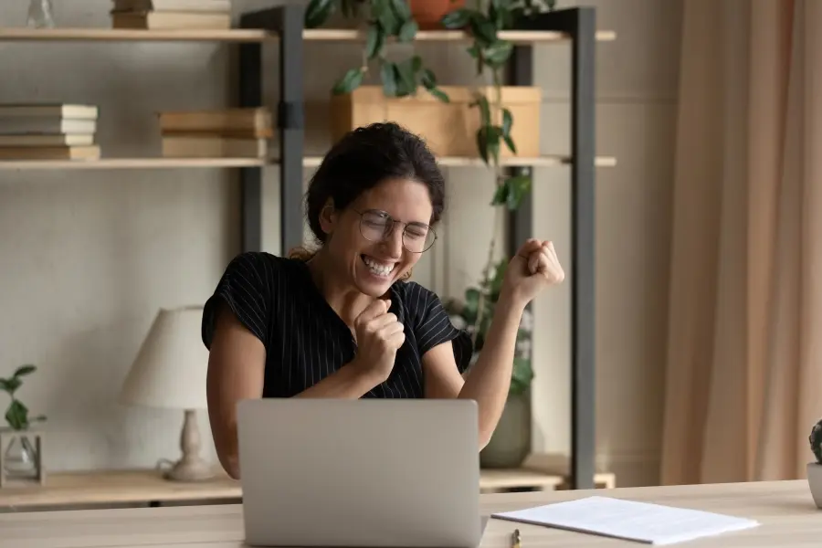 Happy female researcher in front of laptop